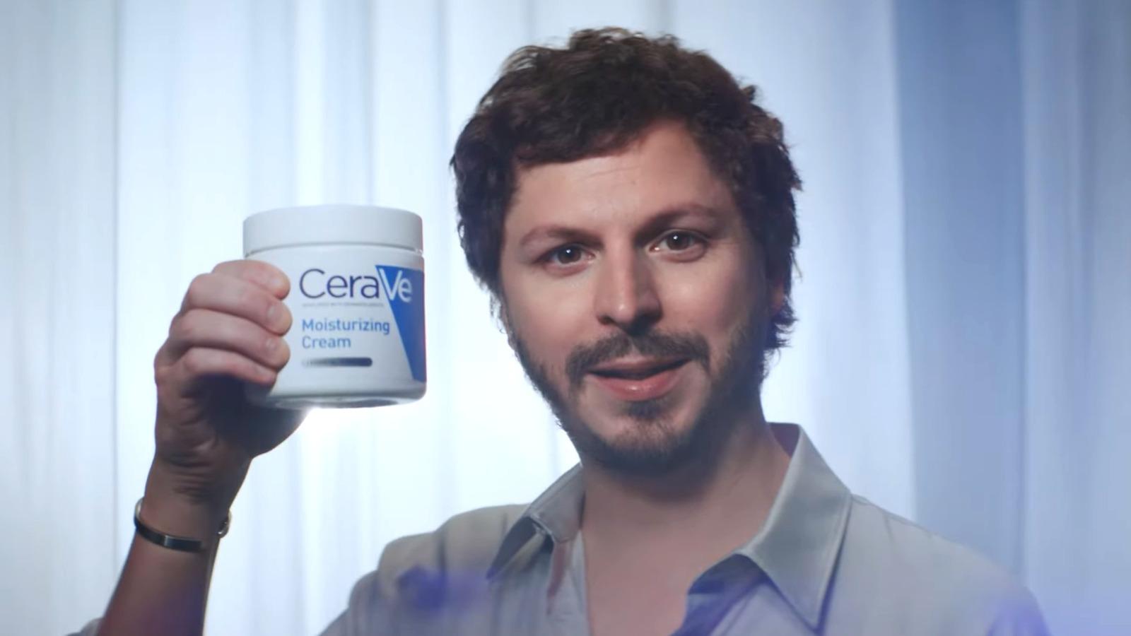 A man holding a jar of CeraVe moisturizing cream, a product featured in the CeraVe x Michael Cera marketing campaign.