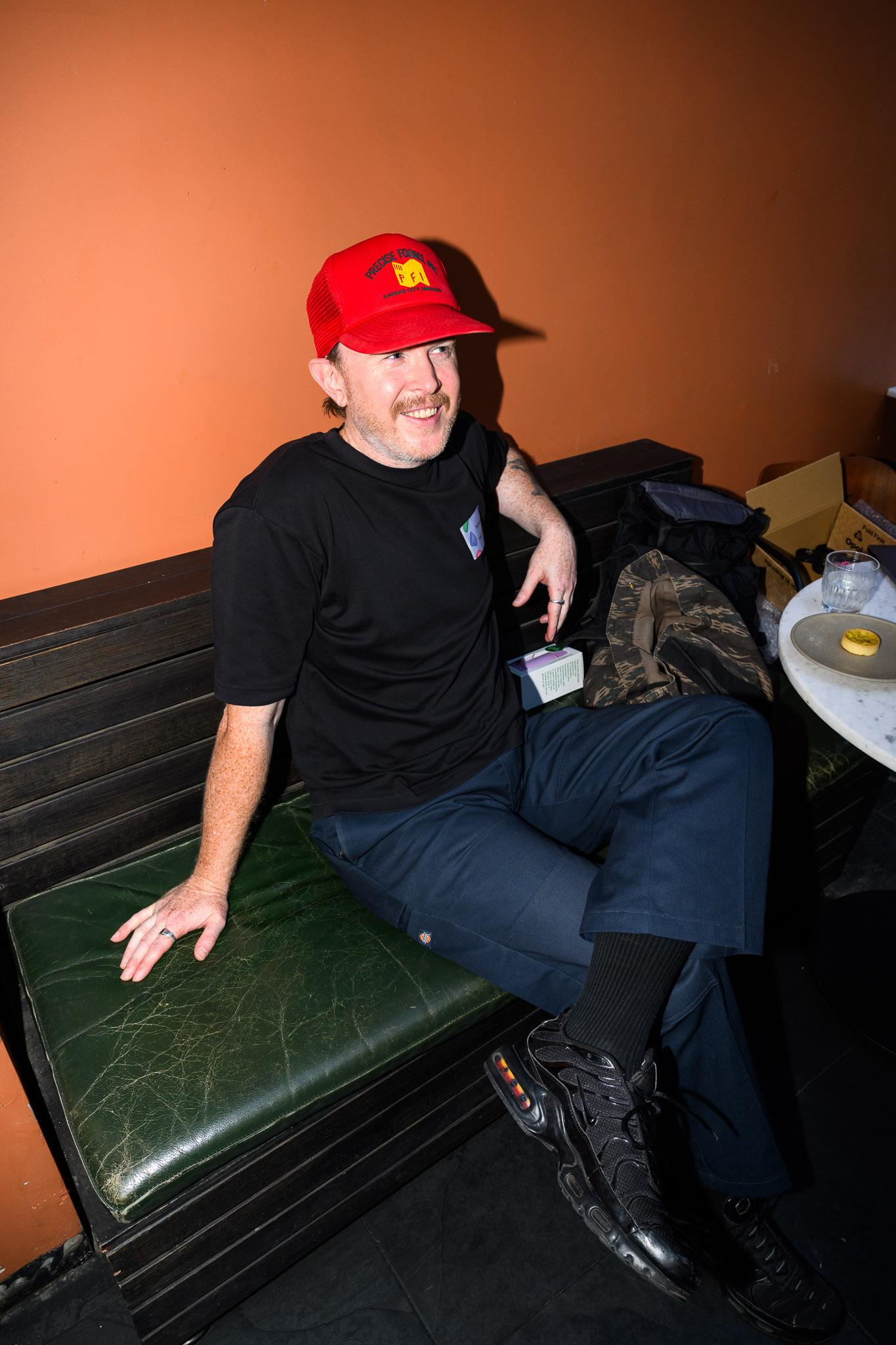 A man wearing a red baseball cap.