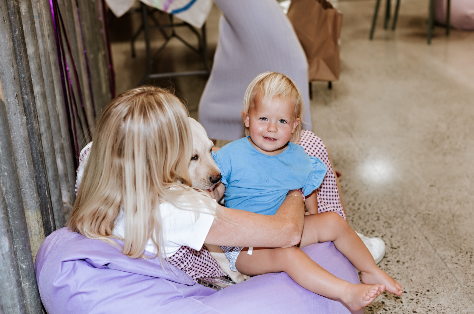 Woman holding baby with blonde hair 