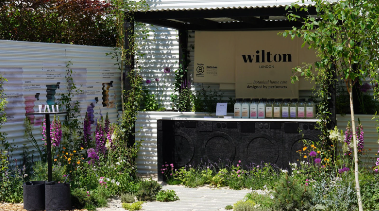 A garden sign displaying the name 'Wilton', representing Wilton London, a brand known for its perfumer-designed, ethically sourced laundry products with lasting botanical scents.