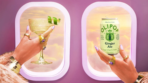 A woman holding a brightly colored can of OLIPOP Ginger Ale, a popular beverage in the consumer packaged goods industry