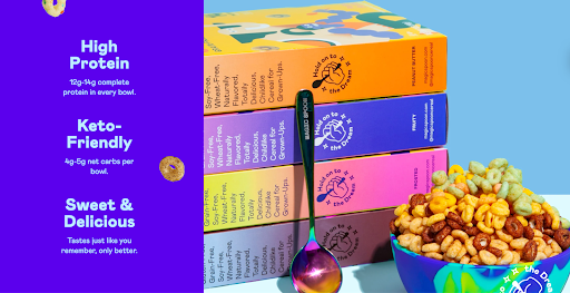 Boxes of Magic Spoon cereal lined up next to a bowl of cereal, representing the product's placement in the consumer packaged goods industry
