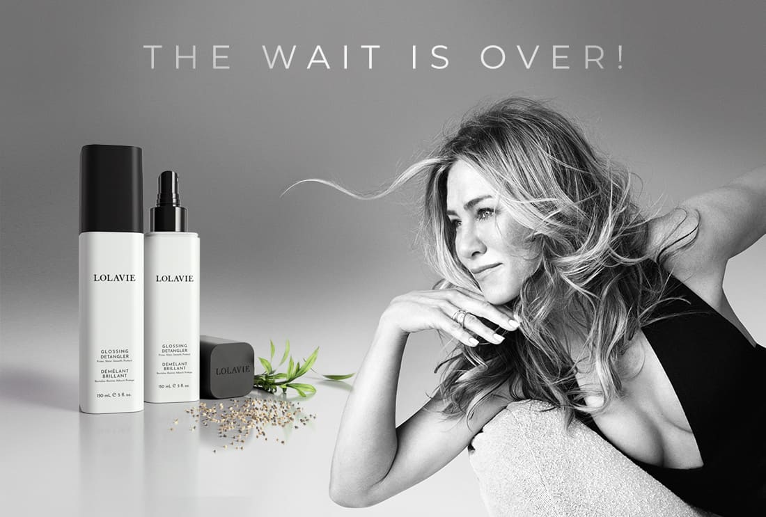 A black and white photograph of actress Jennifer Aniston, known for her iconic hair styles, promoting her hair care brand LolaVie. The text 'the watt is over' is overlaid on the image, signifying the end of waiting for a product like this.