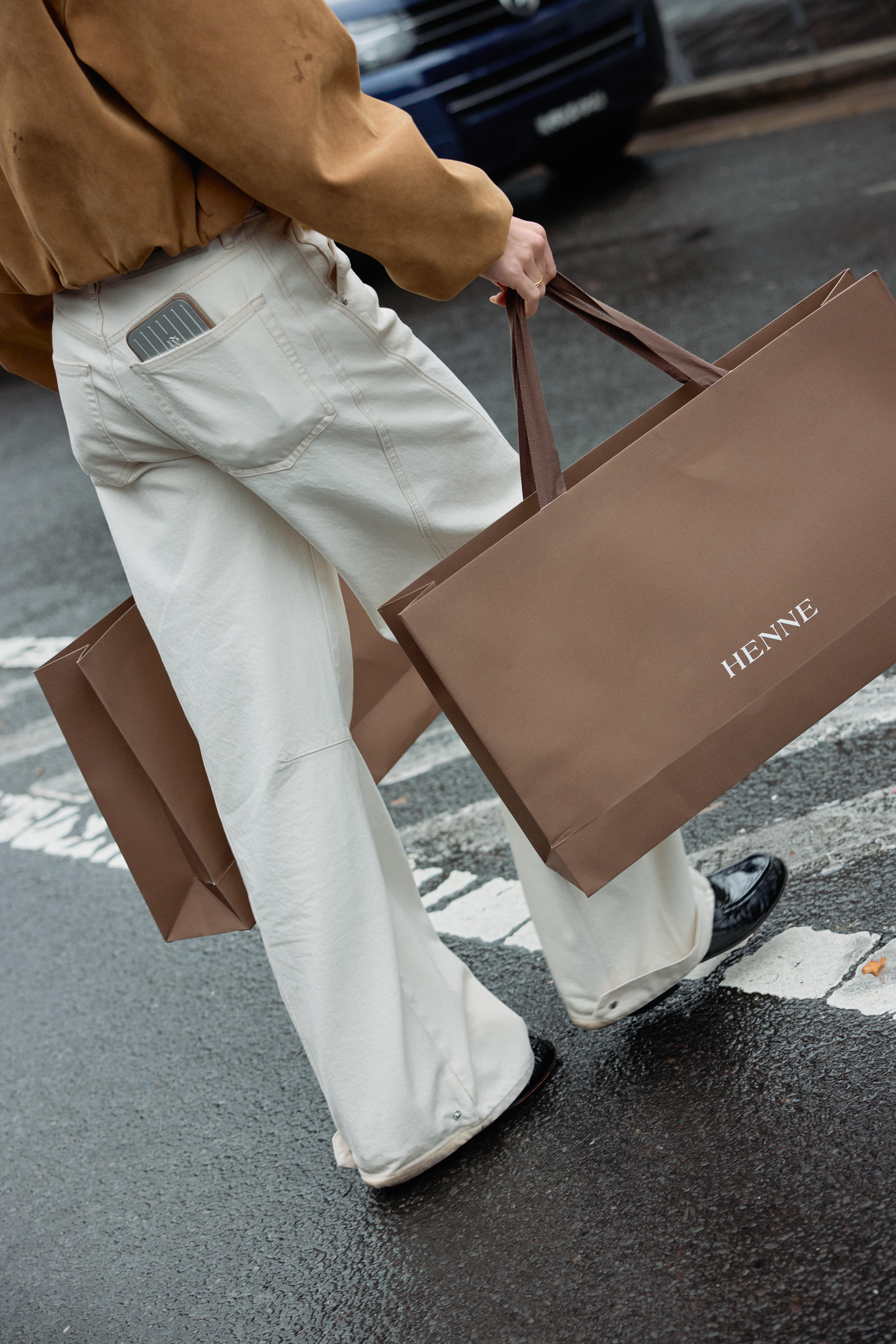 A customer happily carrying a Henne branded brown bag after shopping at the newly launched Henne store in Sydney