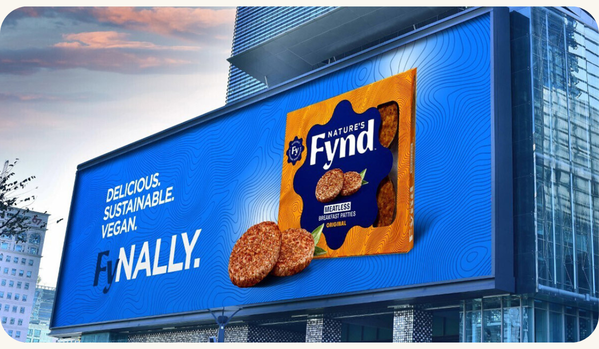 A billboard advertising Nature's Fynd, a sustainable and delicious vegan food brand, known for its unique use of Fy, a nutritious fungi protein. The brand is backed by high-profile investors and aims to increase its visibility and awareness in the market.
