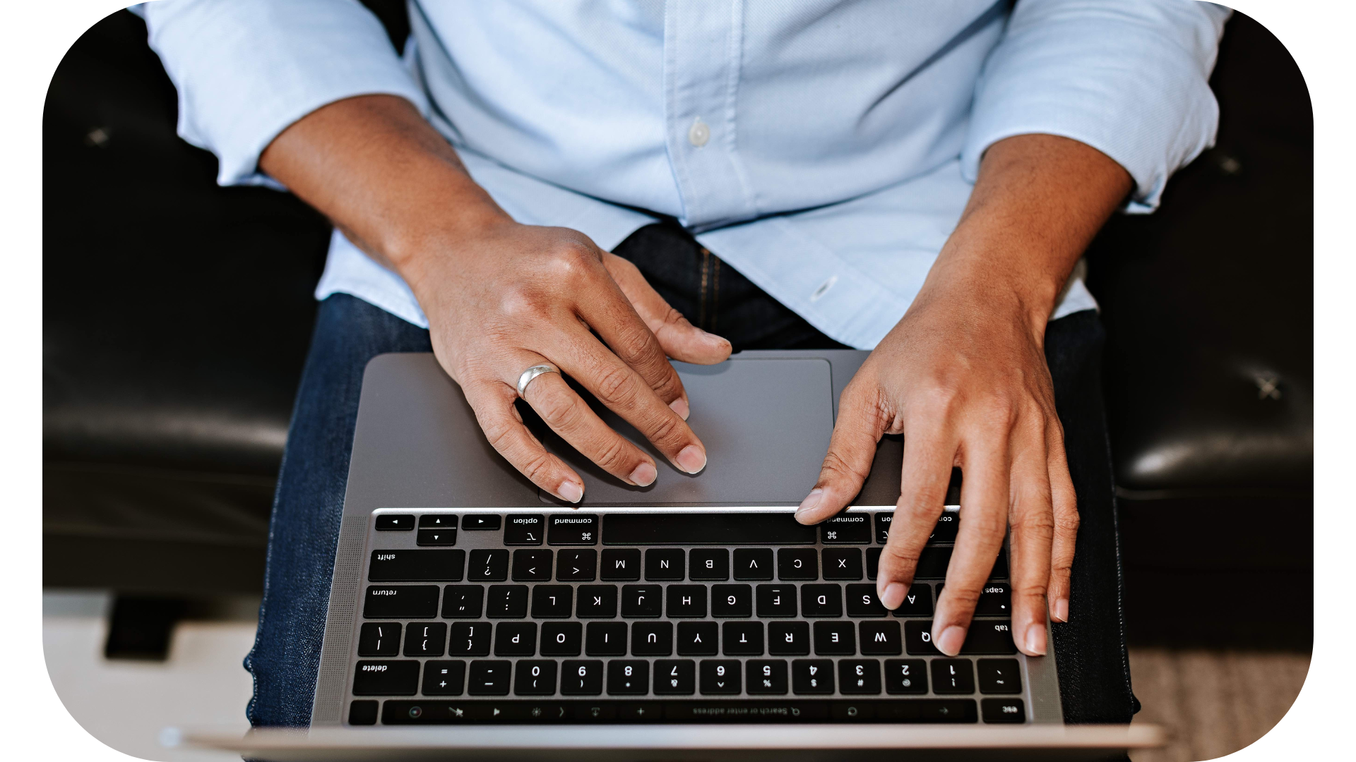 A man diligently working on brand research by typing on his laptop
